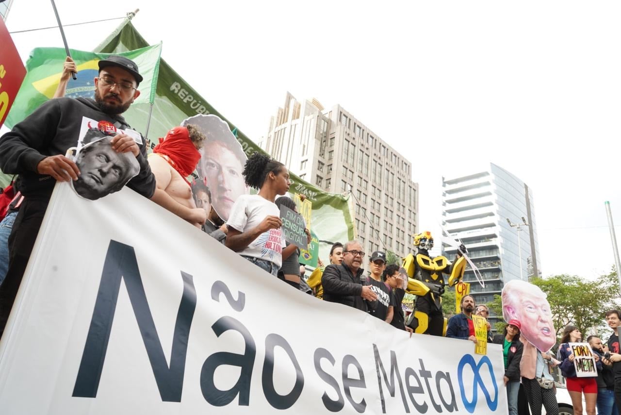 Imagem dos protestantes com um grande cartaz dos dizeres "Não se Meta"